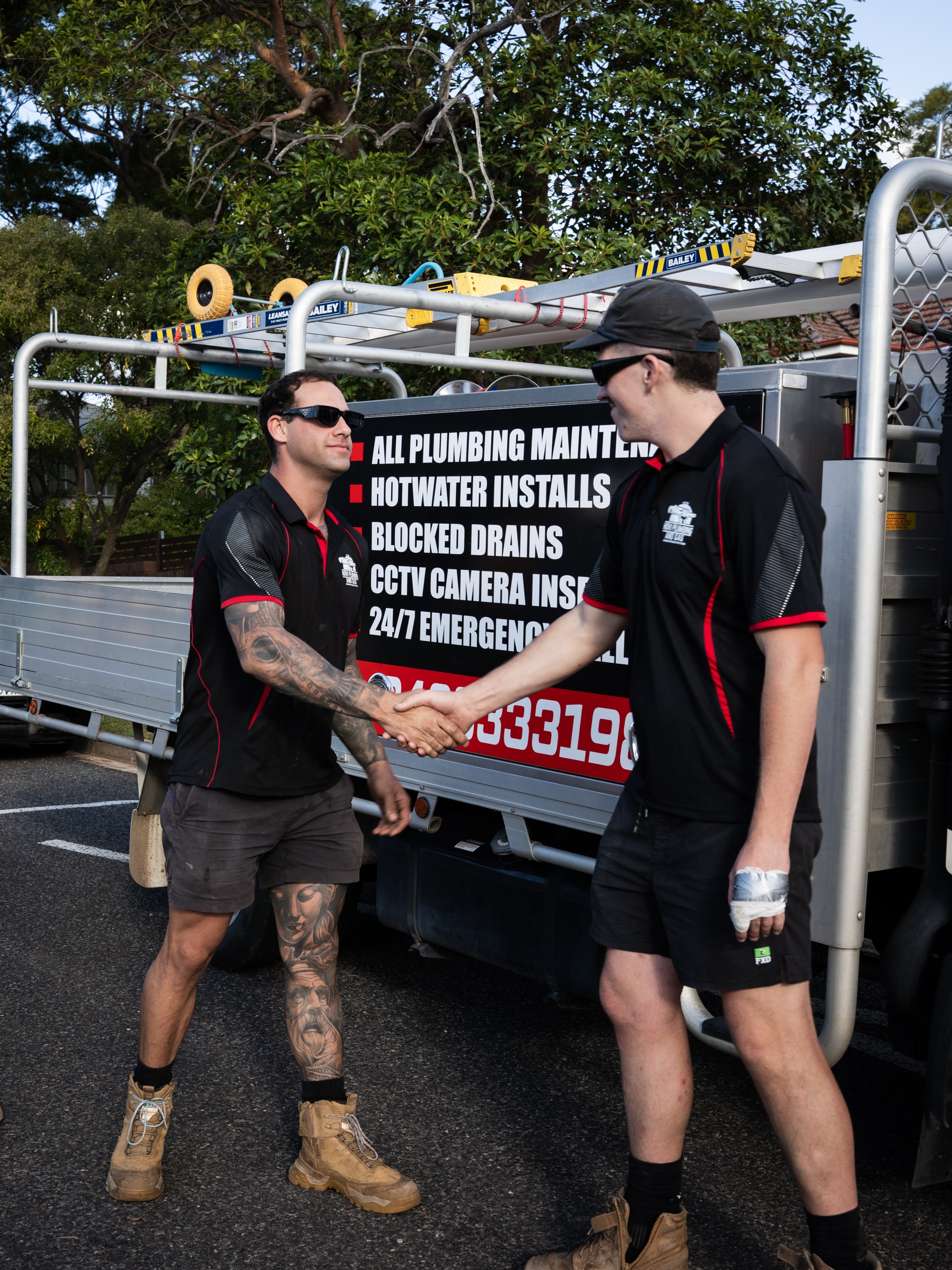 Two of the Hovi Plumbing and Gas team beside their service truck in Muswellbrook